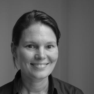 Clara ter Hoeven smiles for the camera in a black and white portrait photograph