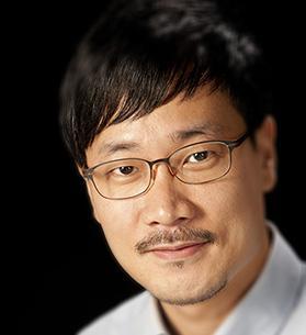 Younbo Jung poses wearing a white collared shirt and glasses